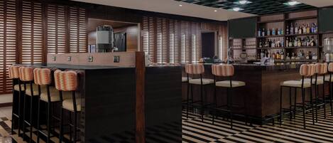 A bar area with a checkered floor, wooden slatted walls, and bar stools with cushioned seats.