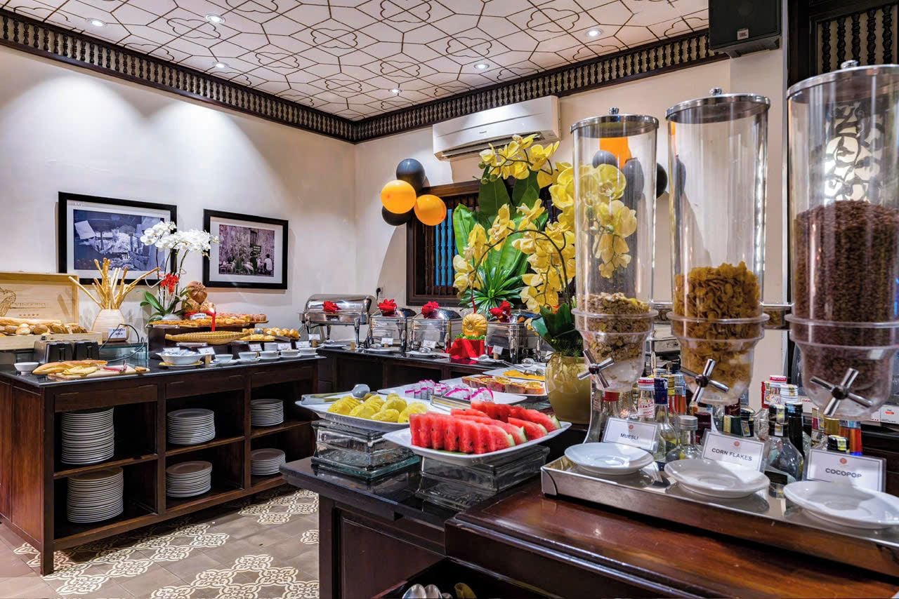 A buffet with various food items and a decorative centerpiece.