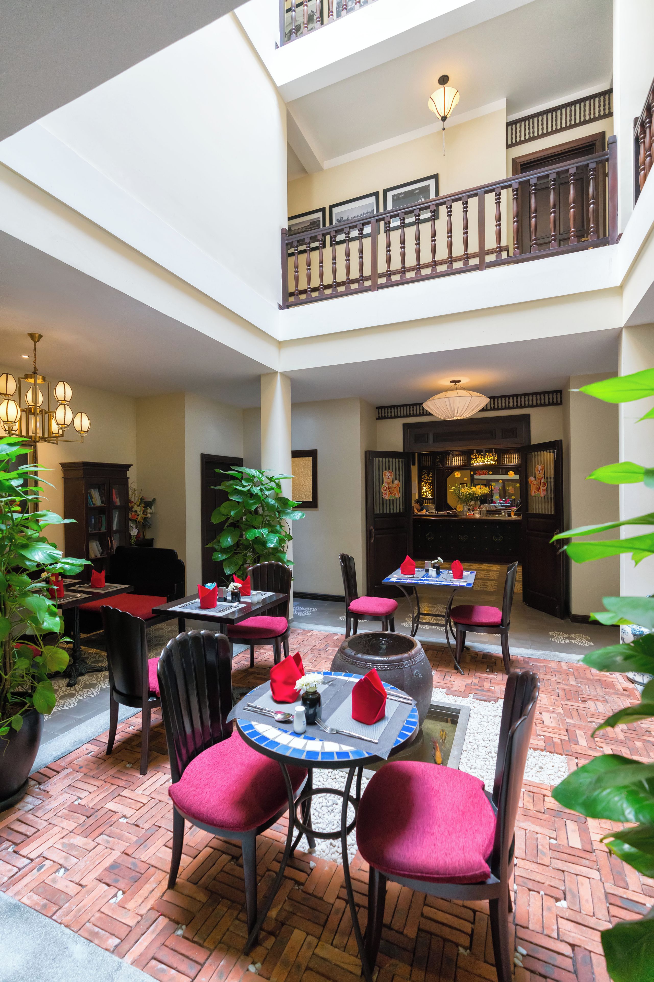 A multi-level indoor space with a dining area, a staircase, and a bar area.