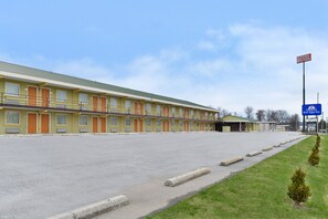 A motel with multiple rooms, a parking lot, and a Best Value Inn sign.
