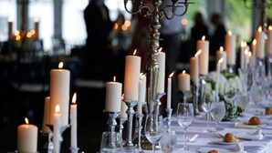 A long table set with candles, glasses, and plates, likely for a formal event. - Stocks Manor Bed and Breakfast (Mechanicsburg)