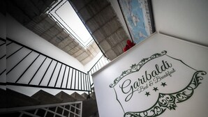 A staircase with a sign that reads "Garibaldi Bed & Breakfast."