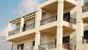 A multi-story building with balconies and railings. - Sugar and Almond - Luxury Apartments (Corfu)