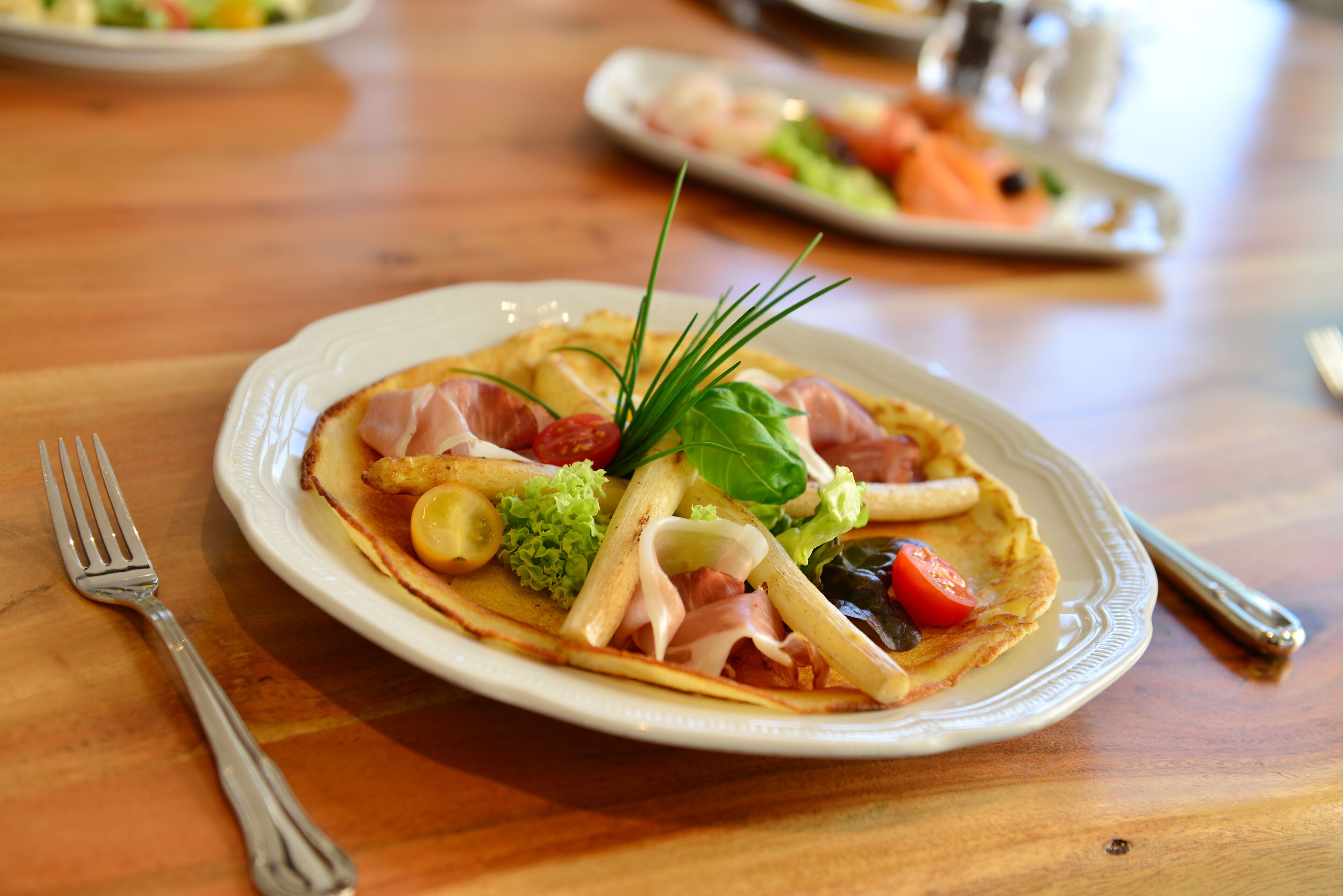 A plate of food with various ingredients on a wooden table.