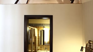 A bedroom with a bed, a nightstand, and a hanging light fixture. - Bed & Breakfast Sabir (San Vito Lo Capo)