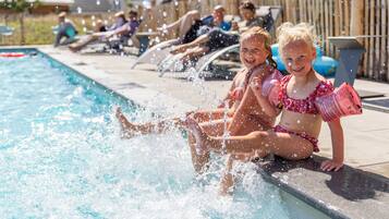 Guests can enjoy a refreshing swim in the pool surrounded by lounge chairs.