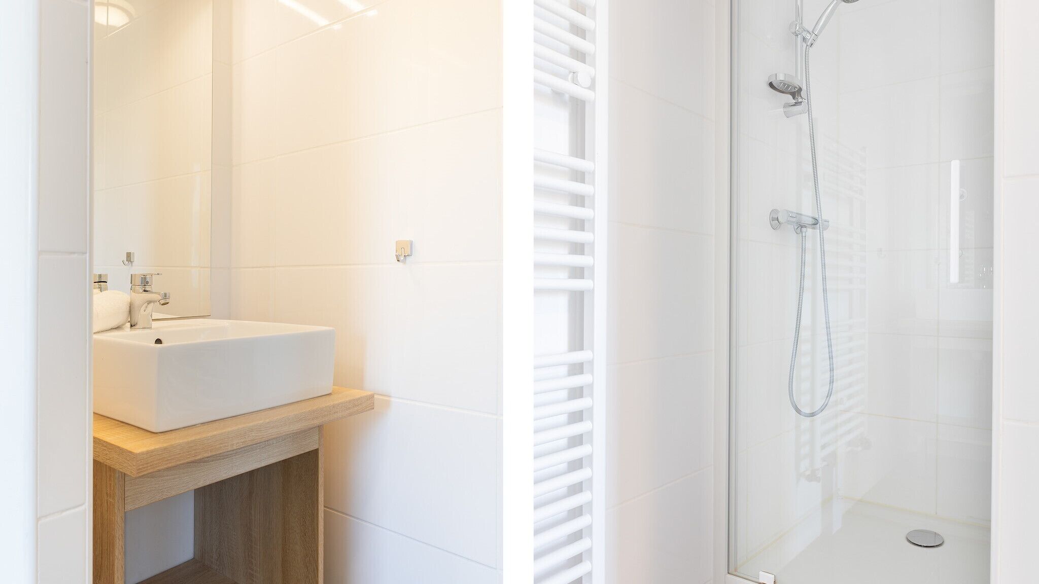 A bathroom with a white sink, mirror, and shower.