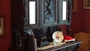 A dark wooden cabinet with intricate carvings and two glass panels. - Fine Fleur Bed & Breakfast (Bruges)