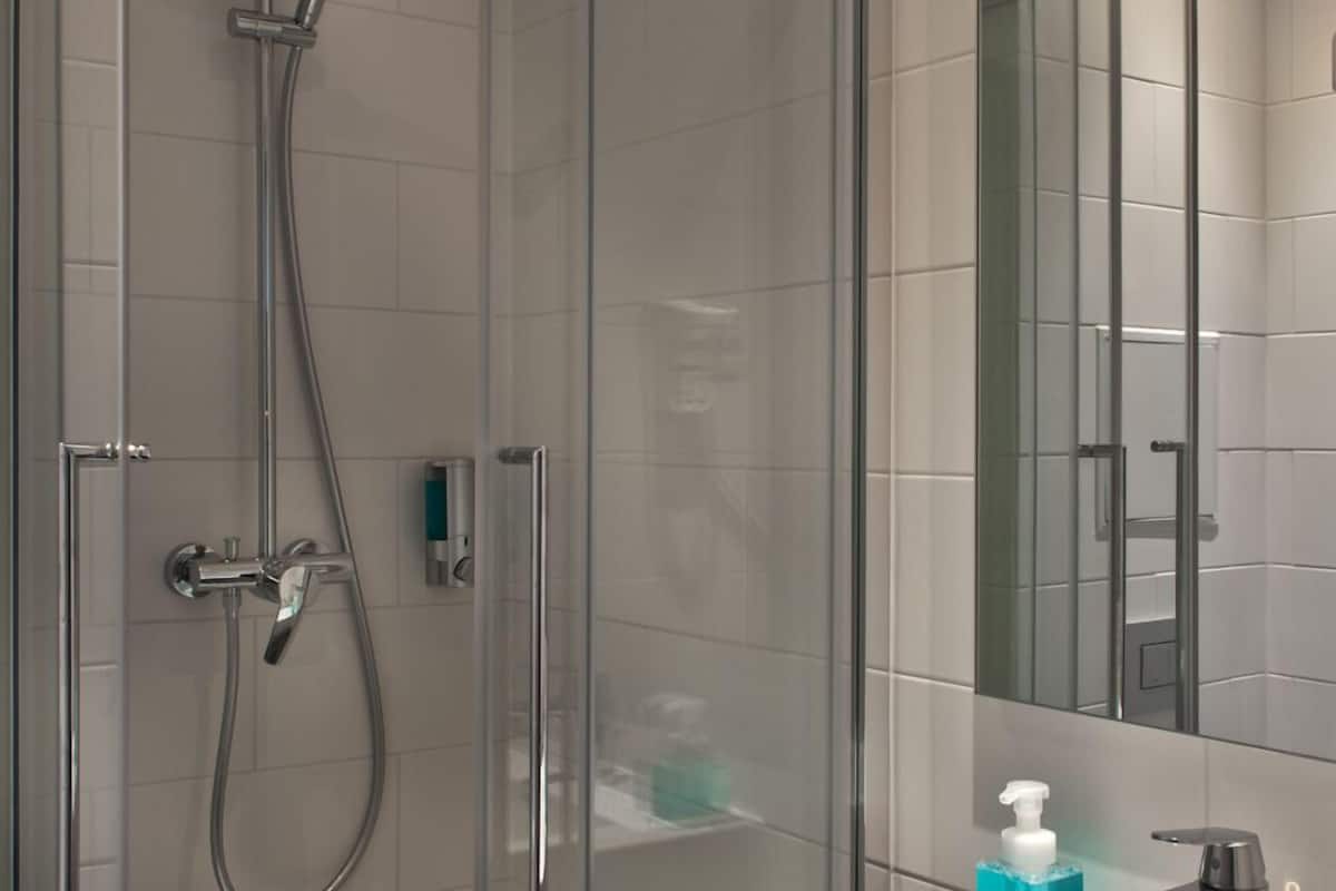 shower, rainfall showerhead, hair dryer, towels