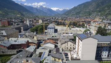 A town with historic buildings, a prominent church, and a mountain backdrop.