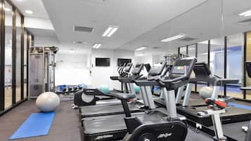 A gym with treadmills, exercise balls, and weight machines.