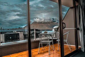 A balcony with a view of a mountain and a body of water. - The Lofts Apartments (Queenstown)
