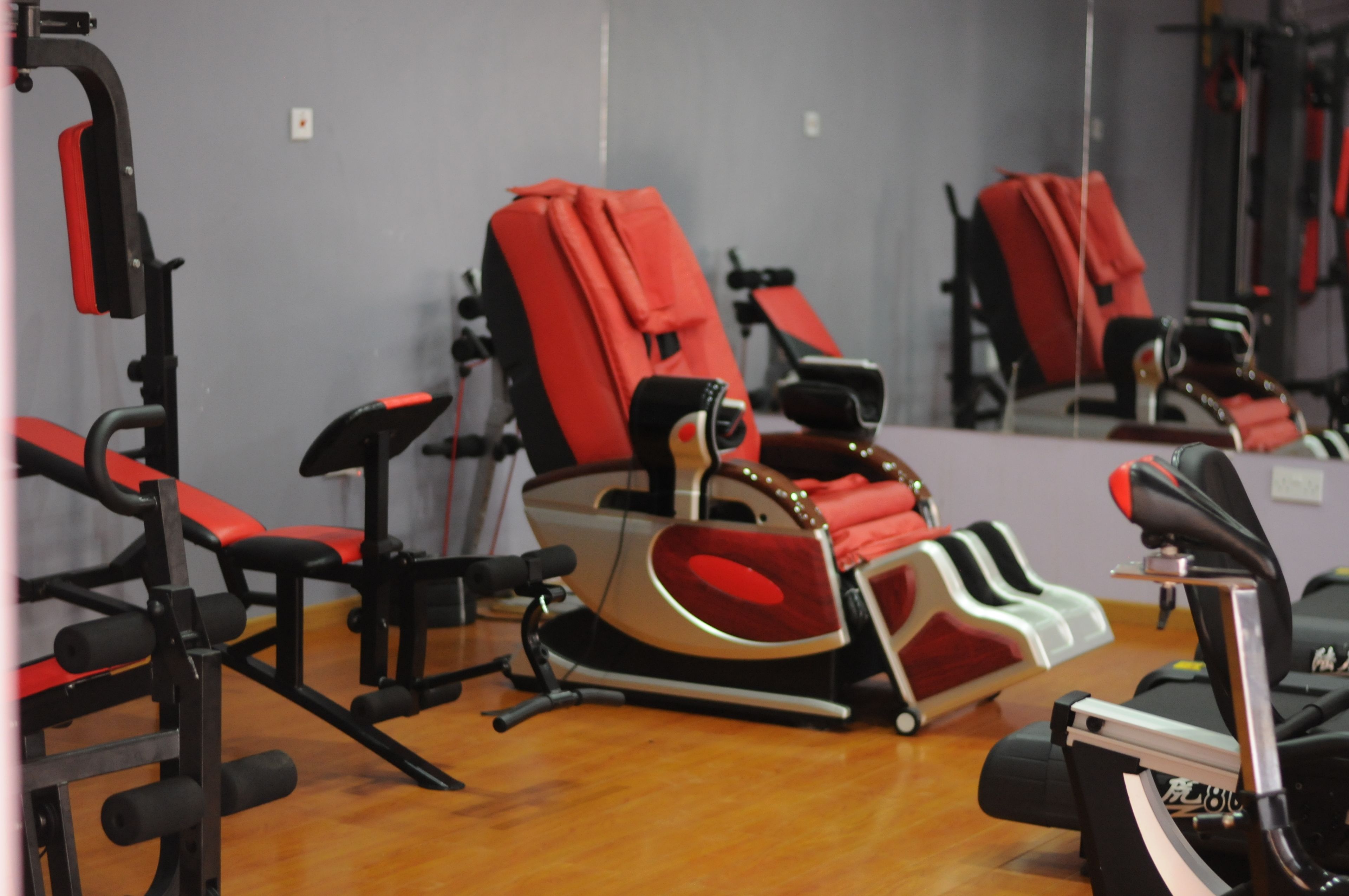 A gym with exercise equipment, including treadmills and weight machines.