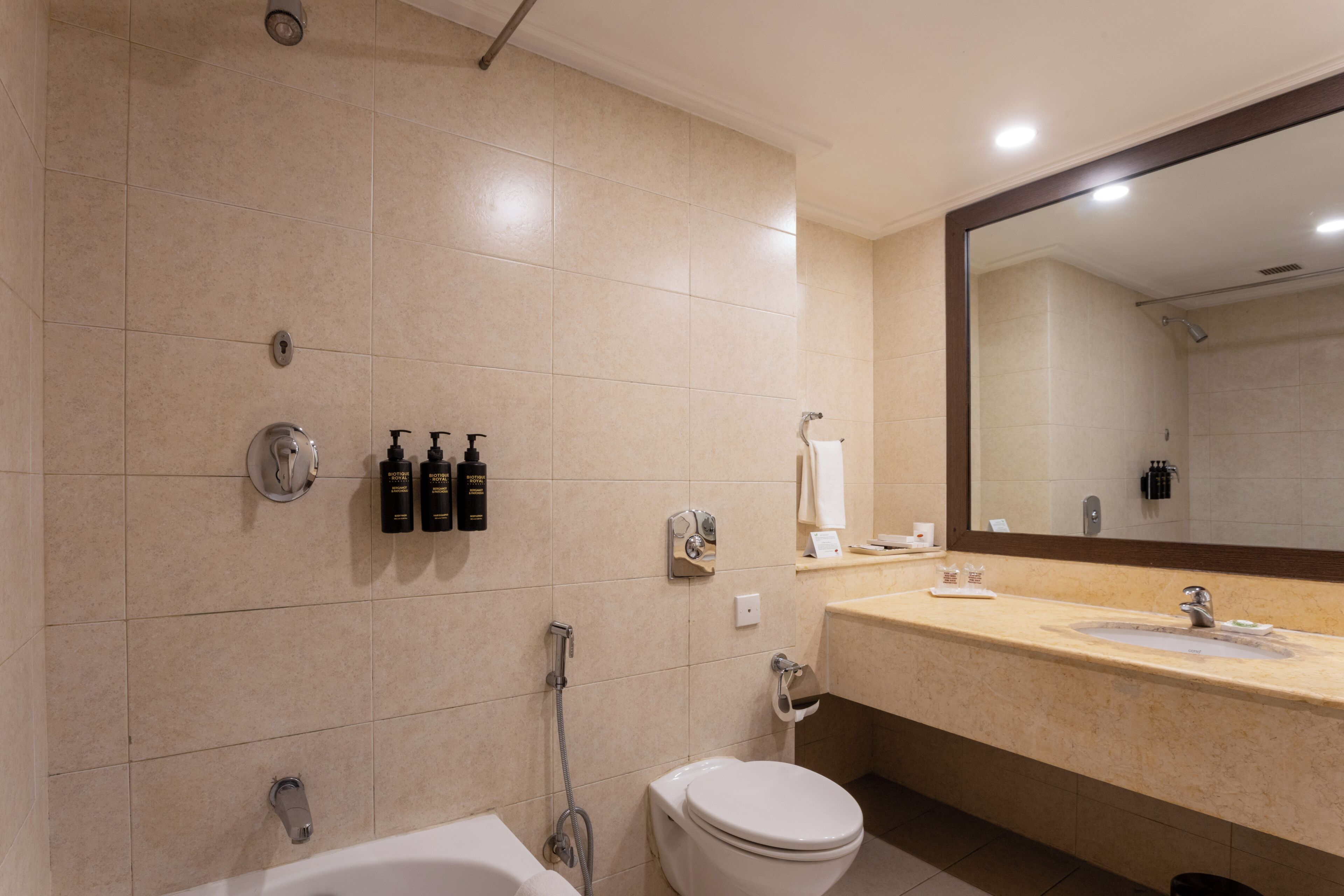 A modern bathroom with a bathtub, toilet, and sink.