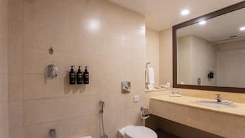 A modern bathroom with a bathtub, toilet, and sink.