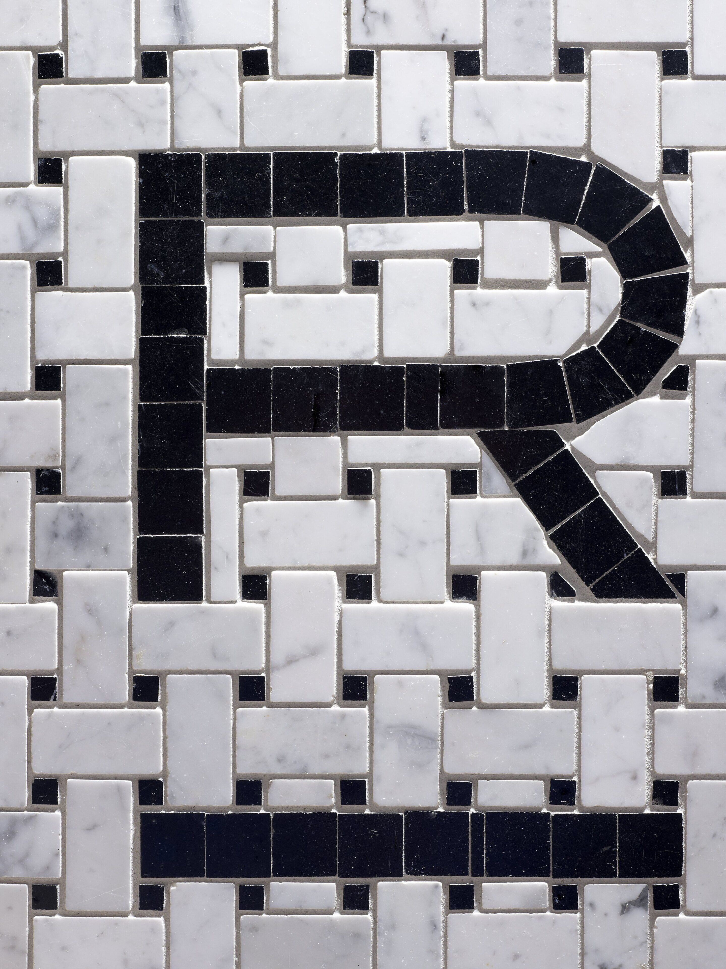 A mosaic pattern with a prominent black 'P' shape.