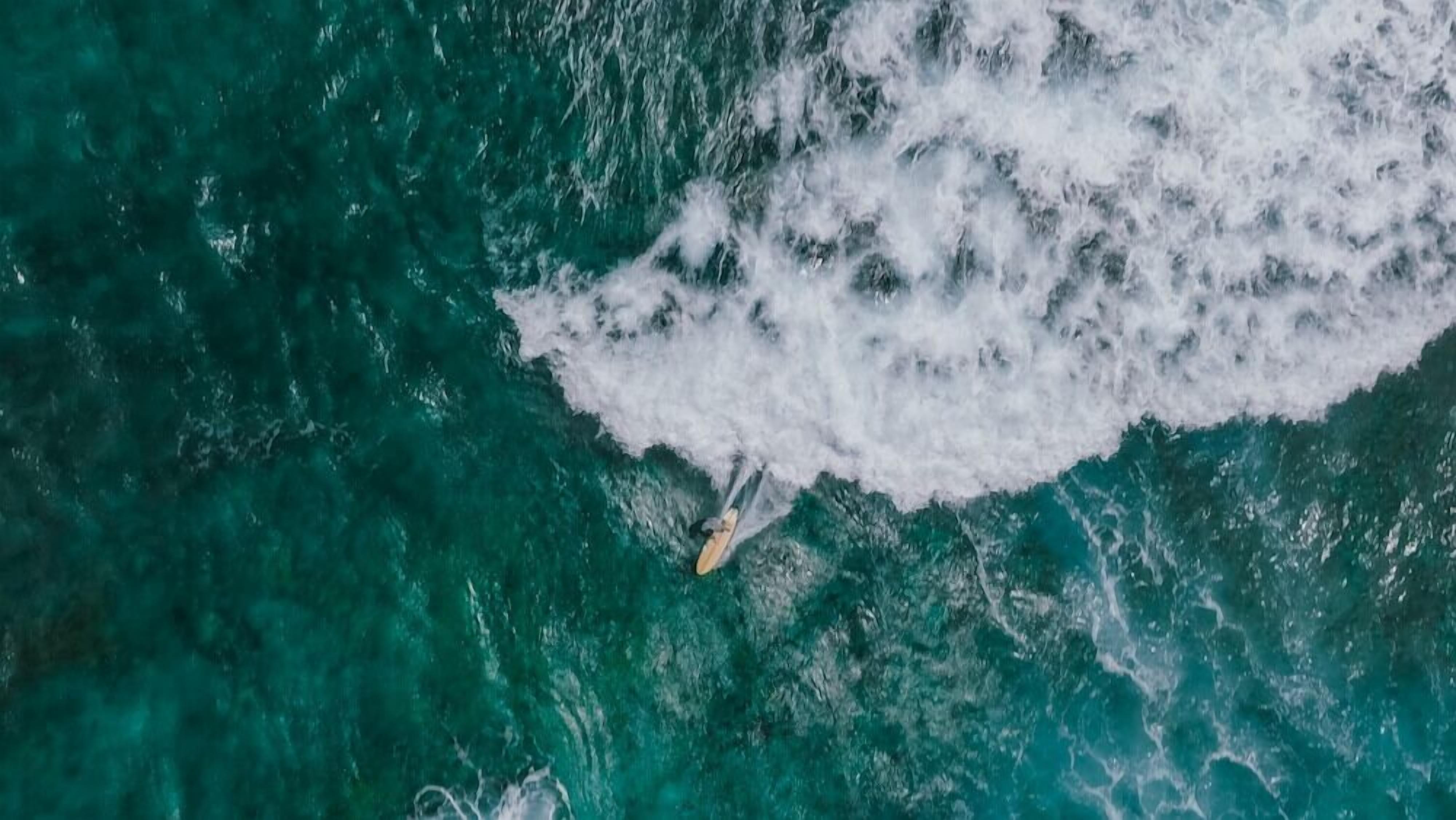 Una persona che fa surf su un'onda nell'oceano.