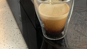 A coffee machine dispensing coffee into a glass. - Citywalk Motor Inn (Rockhampton)