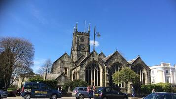 A historic church with a prominent clock tower and Gothic architecture.