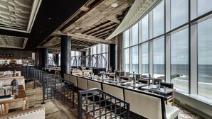 A spacious restaurant with high ceilings, large windows overlooking the ocean, and a modern interior design. - Ocean Casino Resort (Atlantic City)