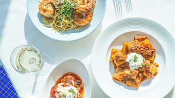 Three plates of pasta dishes on a table.