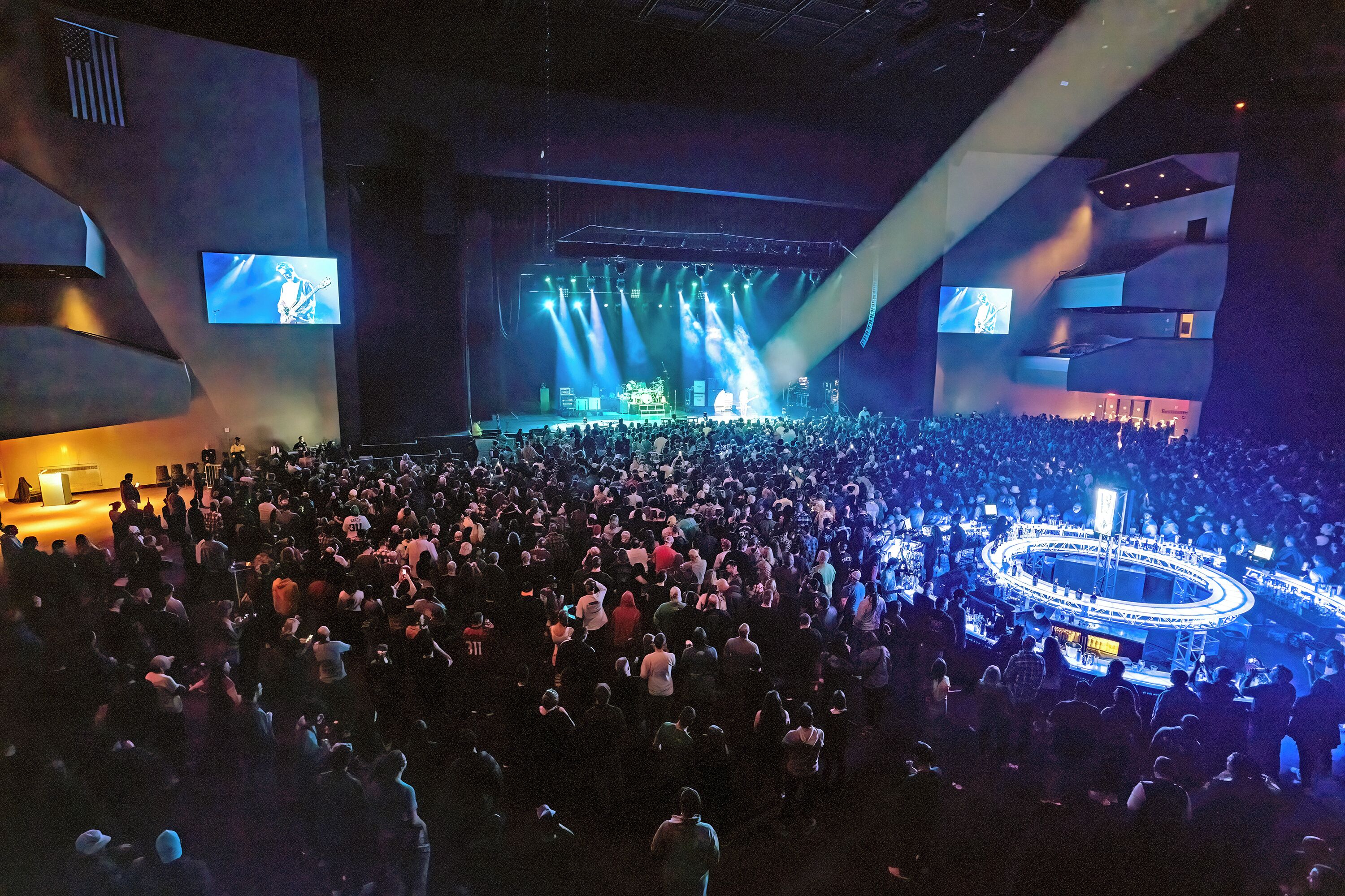 A large indoor venue with a stage and a crowd.