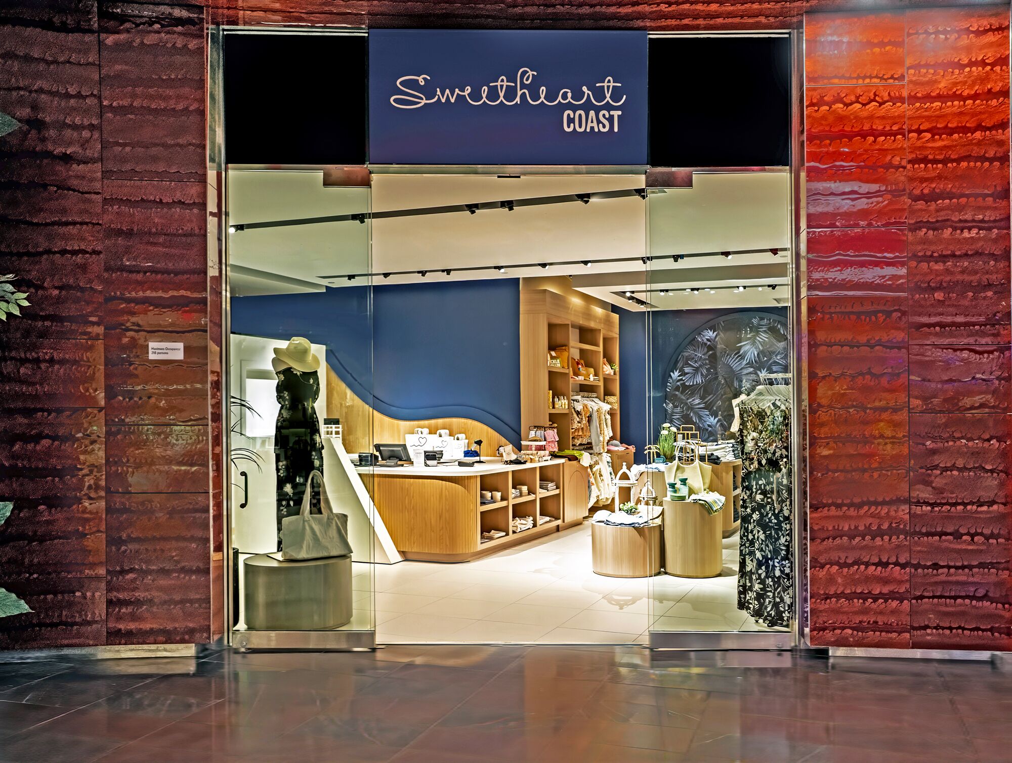 A Sweetheart Coast store with a modern interior, a wooden counter, and a variety of displayed items.