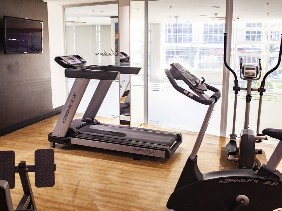 A gym with treadmills, an elliptical, and a stationary bike.