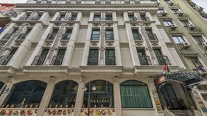 A historic building with a classical facade, large windows, and a prominent entrance with a sign indicating it is a hotel. - The Meretto Hotel İstanbul Old City (Istanbul)