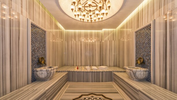 A luxurious bathroom with marble walls, a central bathtub, and two large marble sinks. - The Meretto Hotel İstanbul Old City (Istanbul)