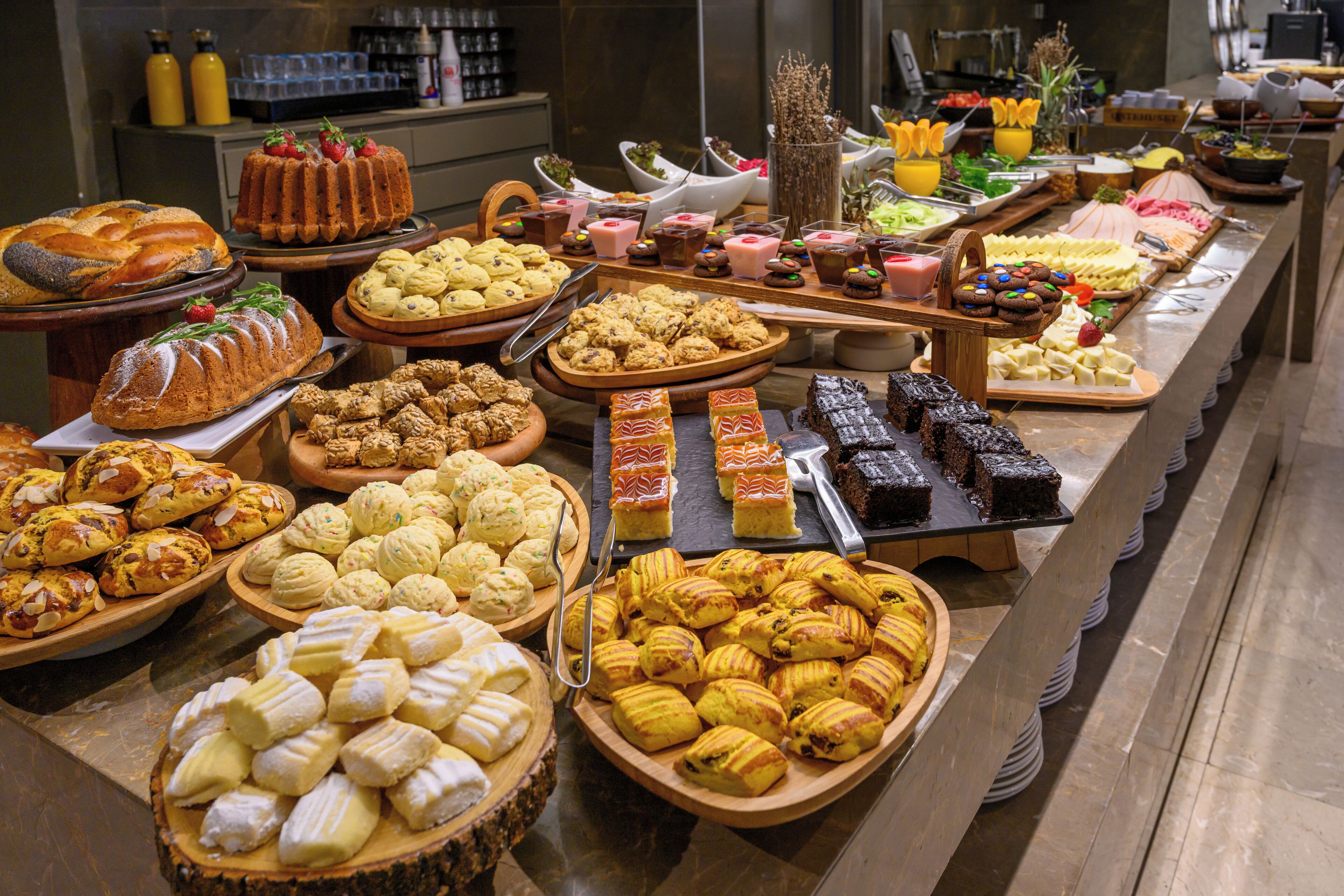 A buffet with various baked goods and desserts.