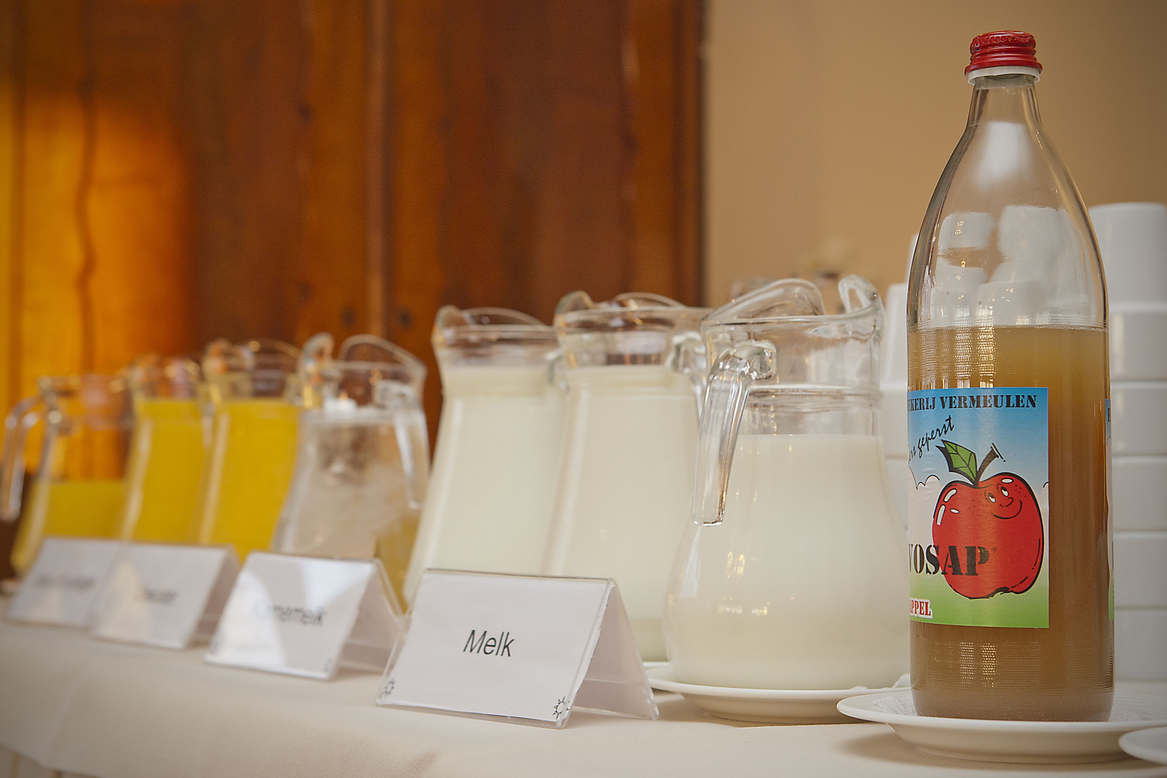 A beverage station with various drinks and a bottle labeled 'VOSAP'.