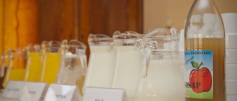 A beverage station with various drinks and a bottle labeled 'VOSAP'.