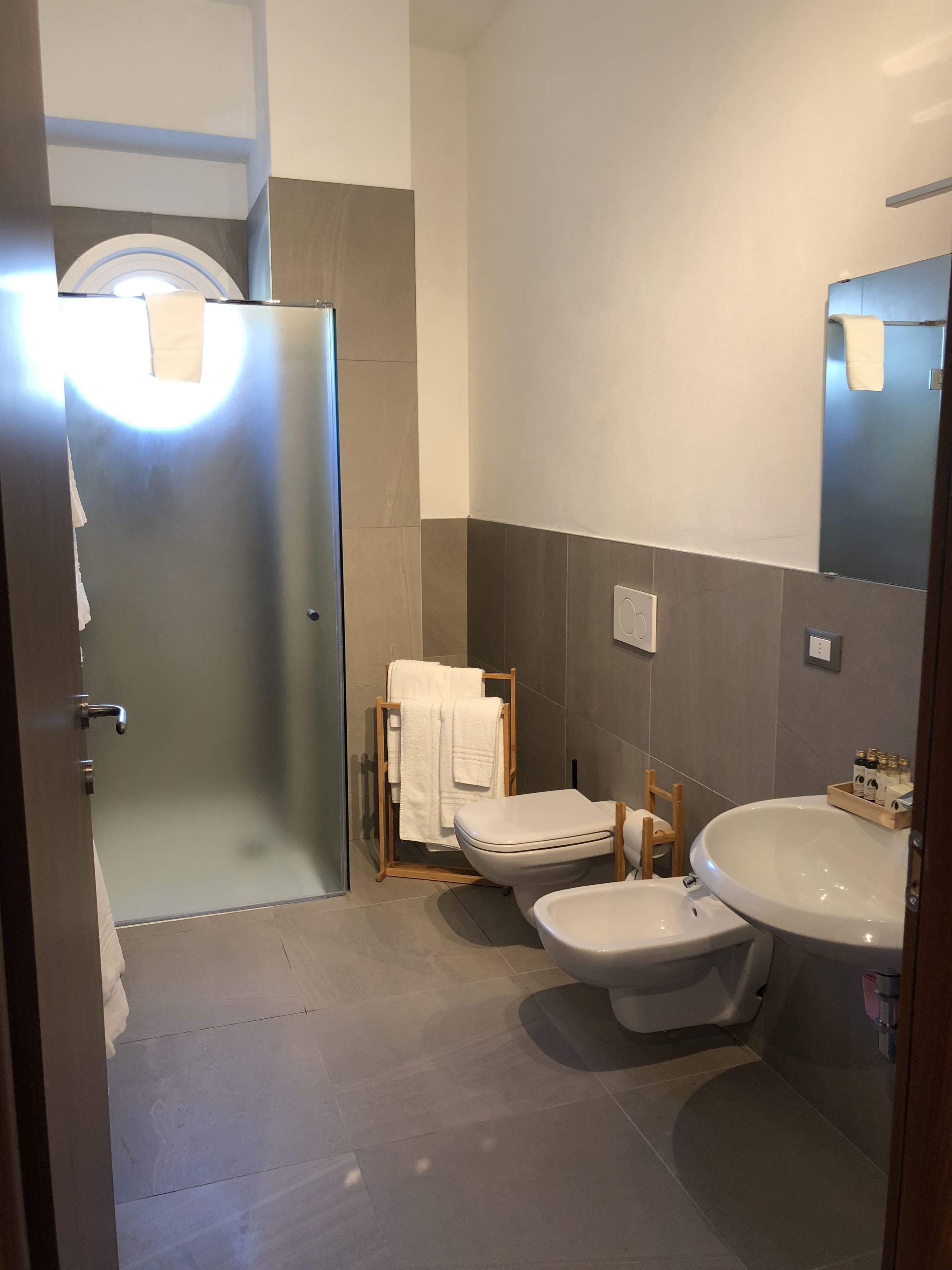 A modern bathroom with a toilet, bidet, and sink.
