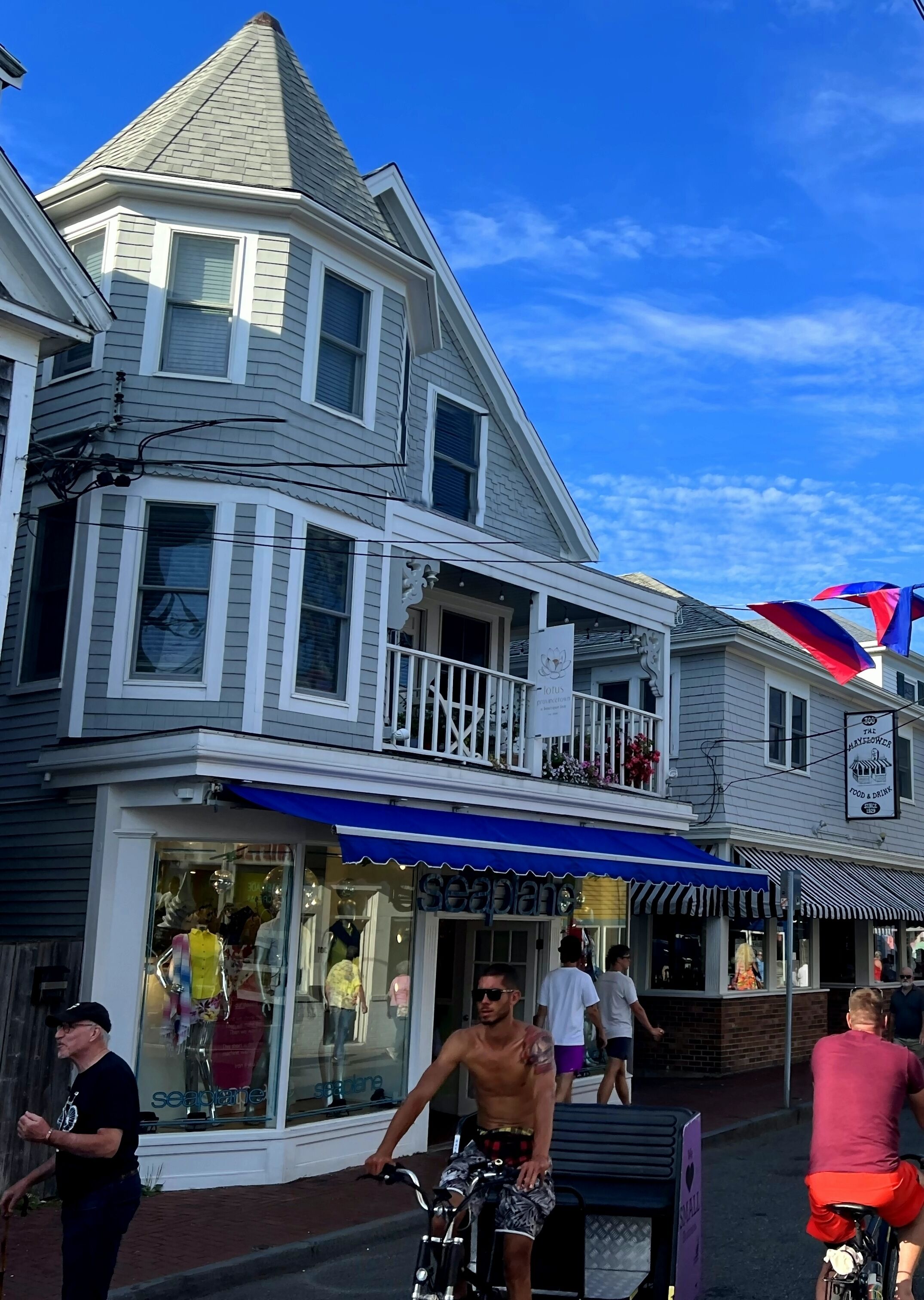 A two-story building with a balcony and a storefront.