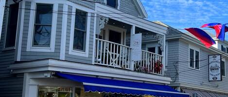 A two-story building with a balcony and a storefront.