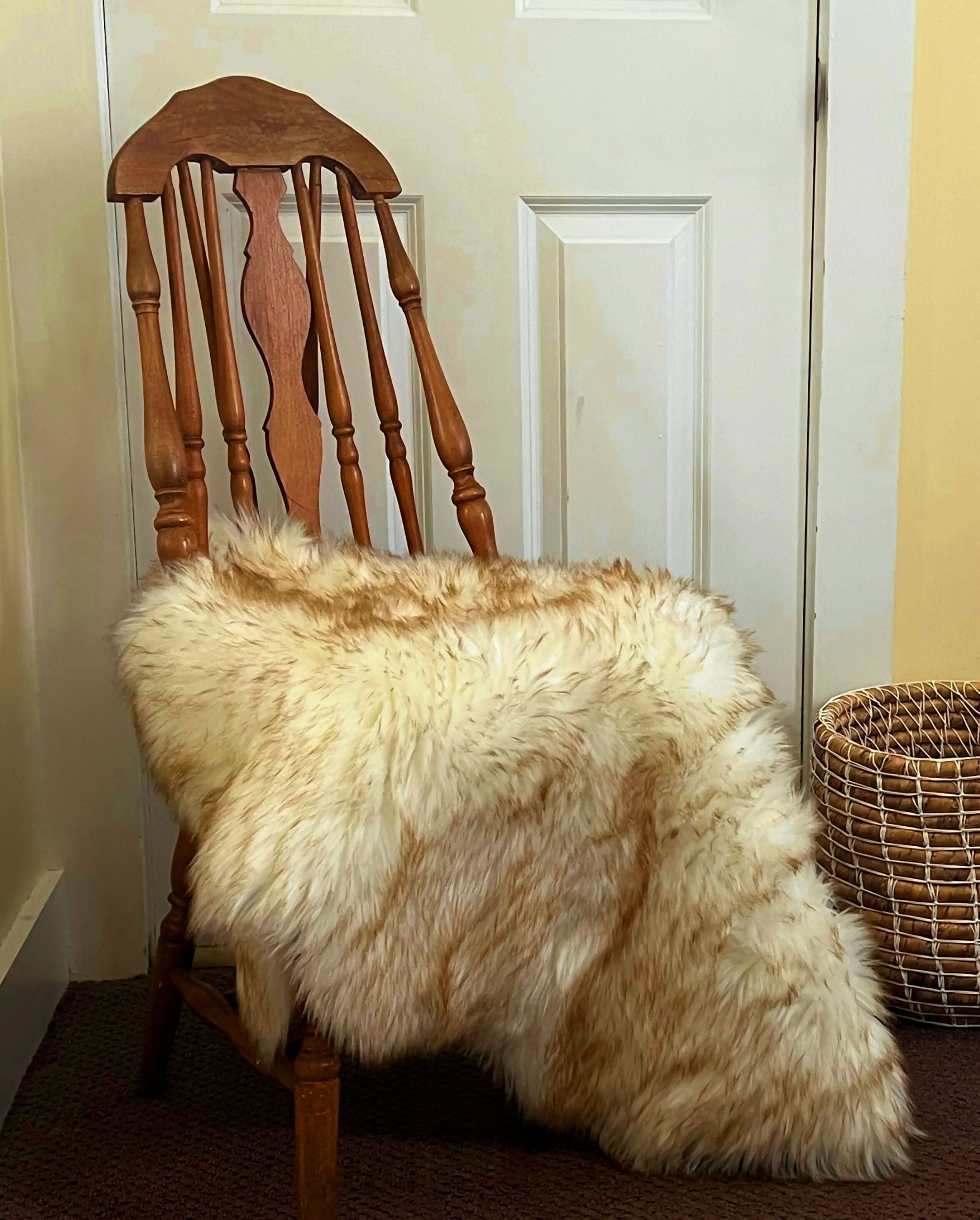 A chair with a furry blanket.