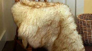 A chair with a furry blanket.
