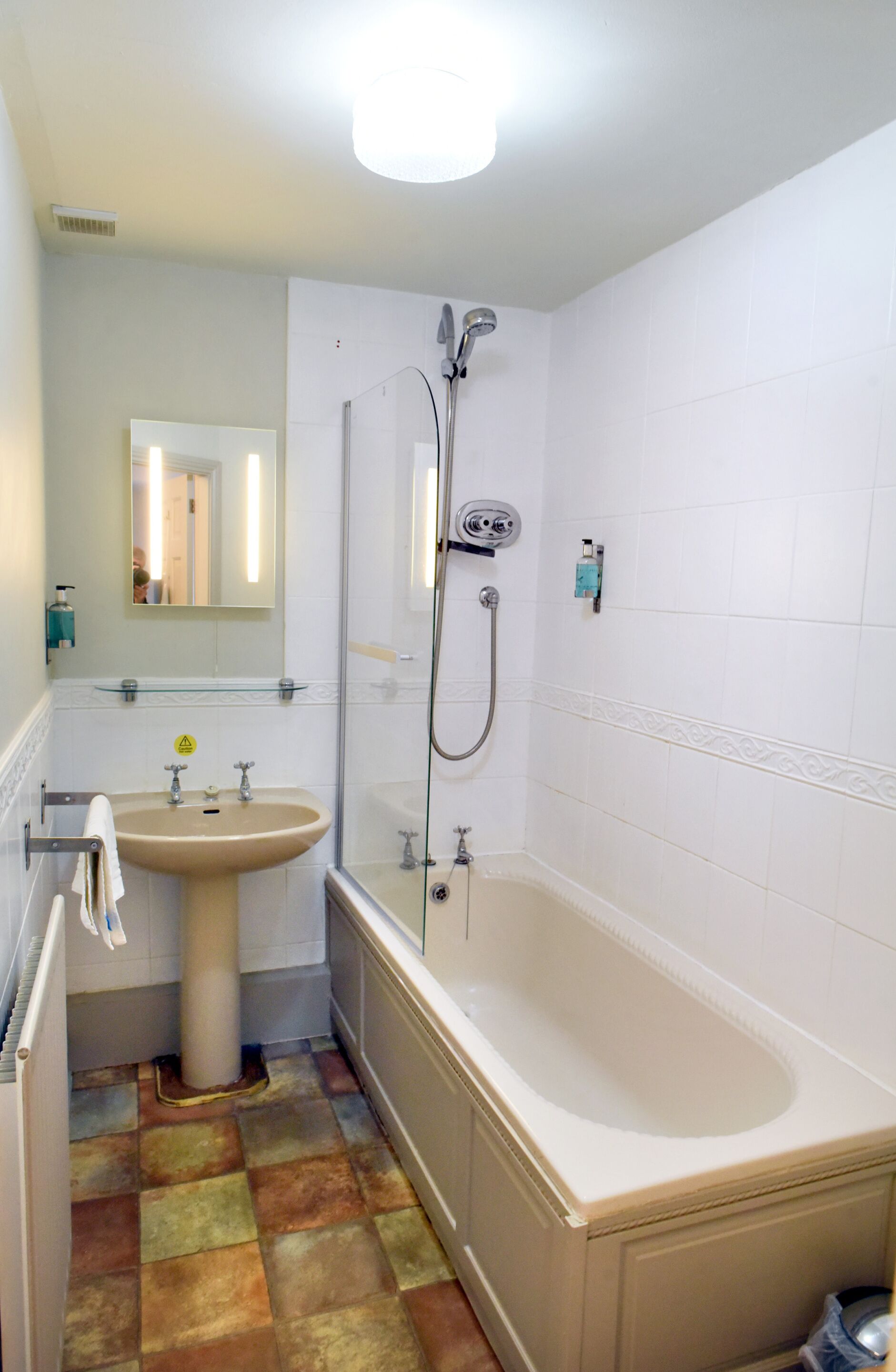 A bathroom with a bathtub, a sink, and a shower.