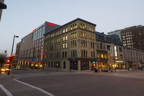 A hotel with a classic facade, multiple stories, and a modern upper section.