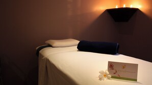 A hotel room with a neatly made bed, a wall-mounted light fixture, and a card on the bed. - Flor de Mayo Hotel & Restaurant - Adults only (Cuernavaca)