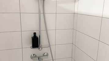 A shower with a handheld showerhead and a handheld hose.
