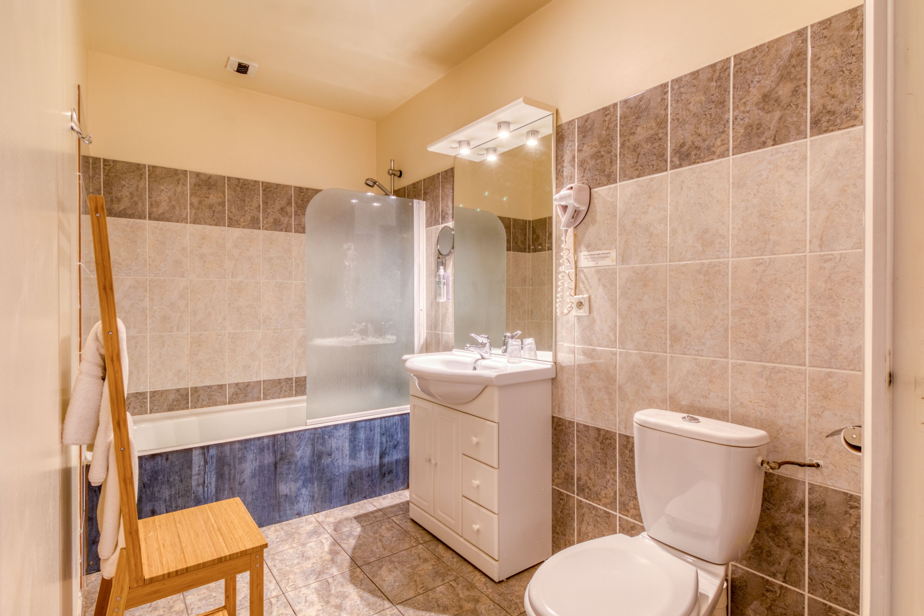 A bathroom with a bathtub, a sink, and a toilet.