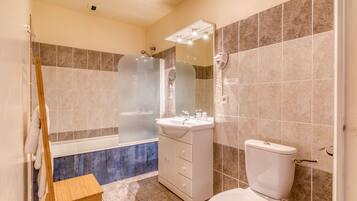 A bathroom with a bathtub, a sink, and a toilet.