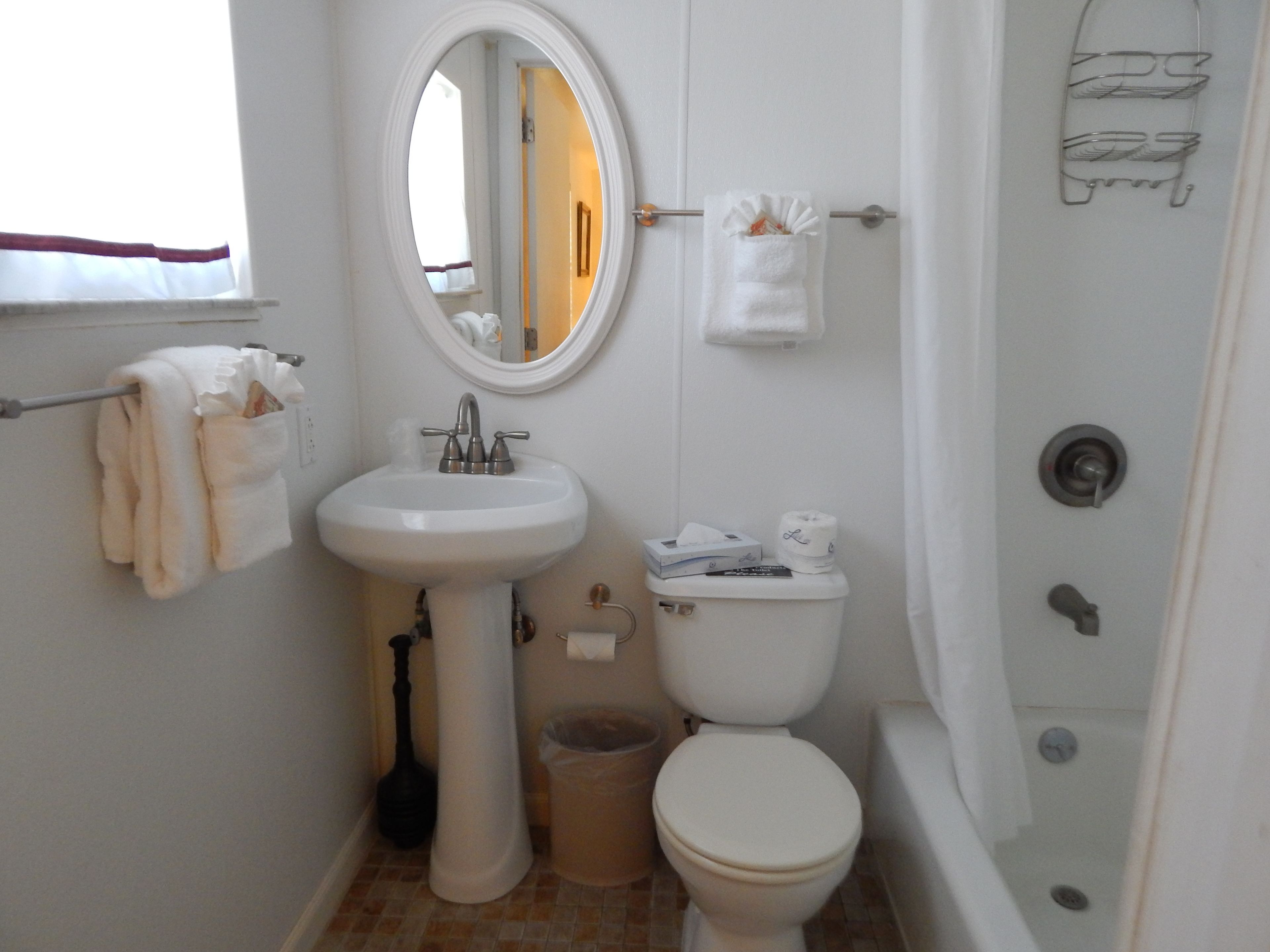 A bathroom with a sink, toilet, and bathtub.