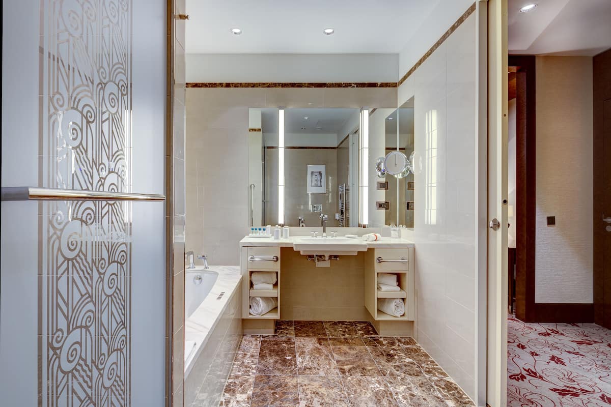 deluxe room | bathroom | separate bathtub and shower, deep-soaking bathtub, rainfall showerhead