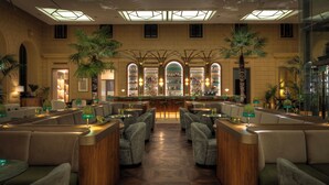 A spacious lobby with a central bar, seating areas, and large windows. - Anantara Palais Hansen Vienna – A Leading Hotel of the World (Vienna)