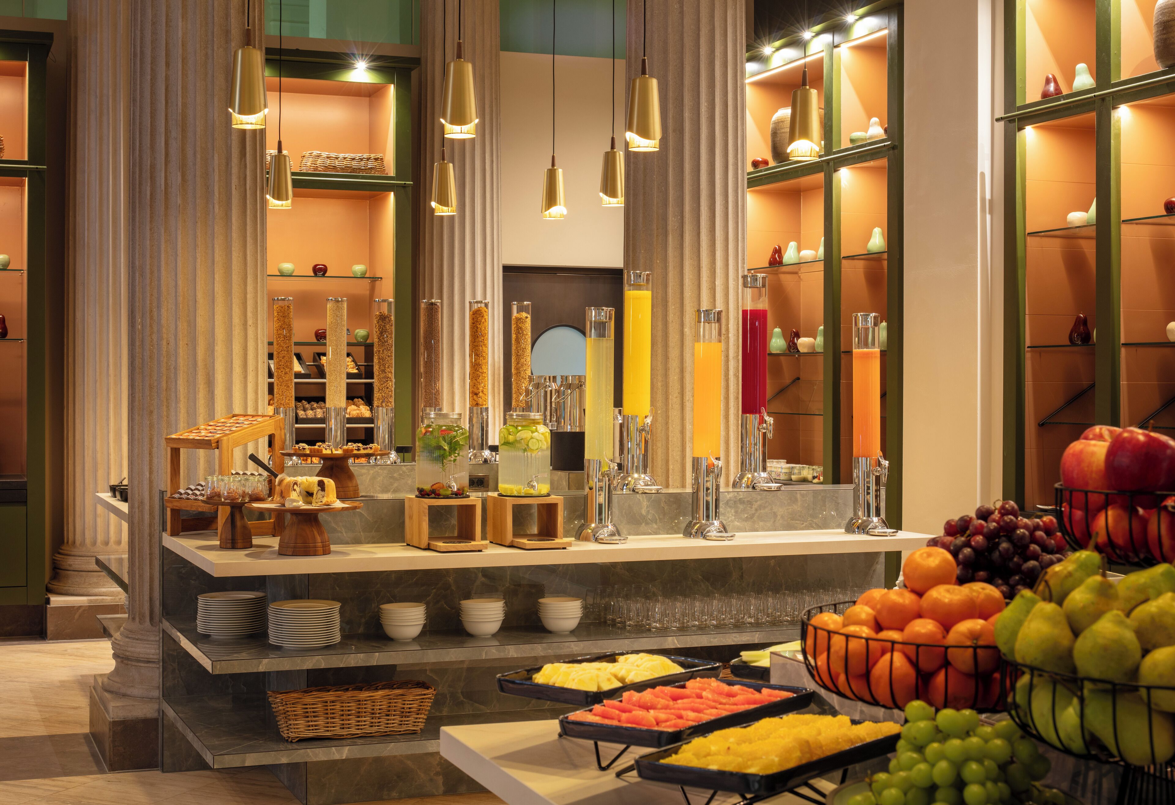 A buffet with various food items and a fruit bowl.