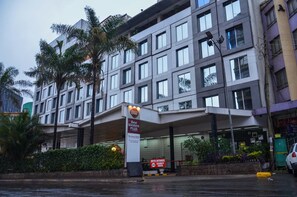 A modern hotel with a prominent entrance, a security checkpoint, and a well-maintained garden area. - Best Western Plus Meridian Hotel (Nairobi)