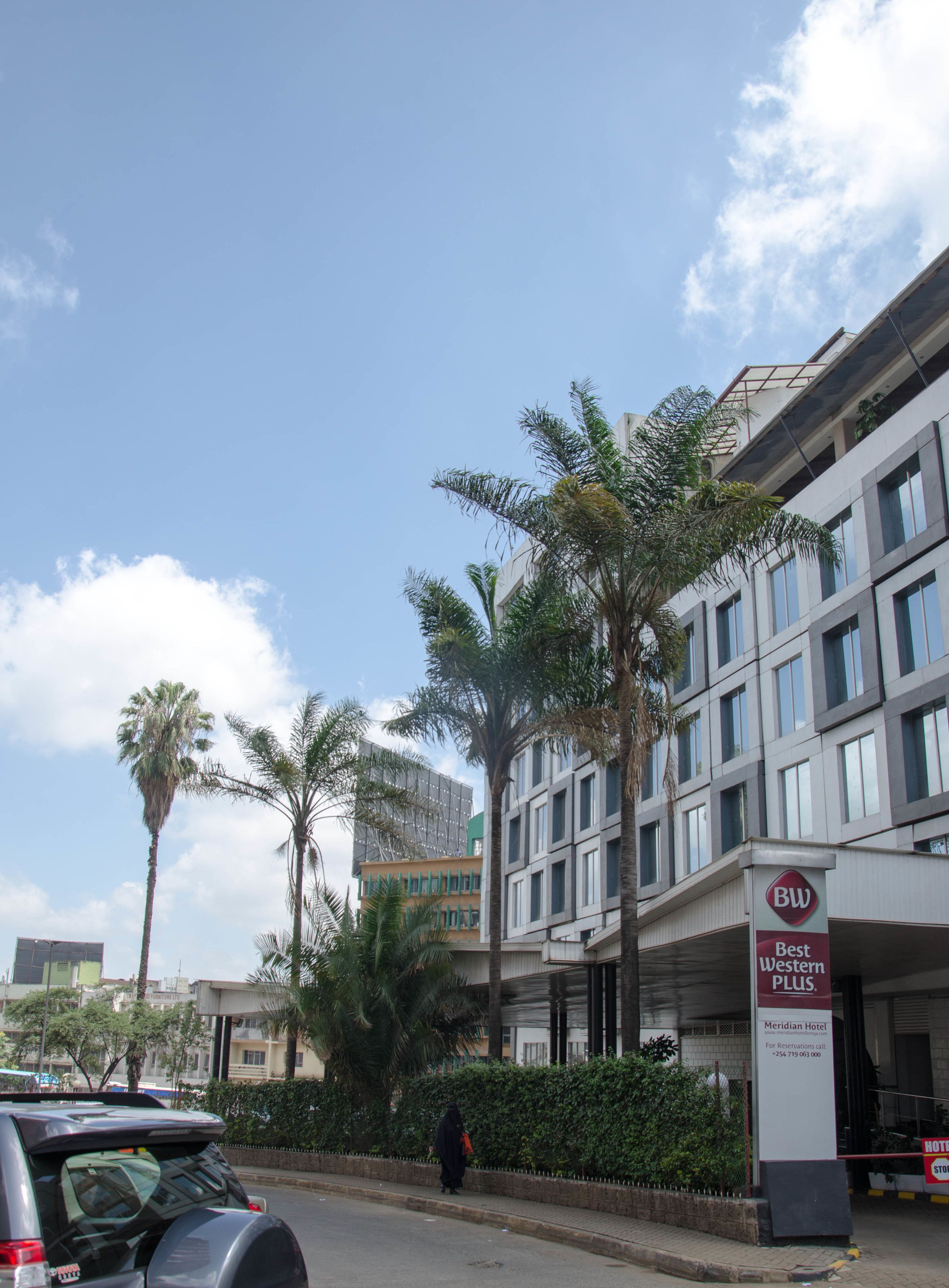 A hotel with a modern design, featuring a prominent sign for the Best Western Plus brand.
